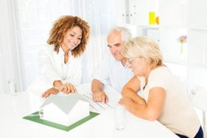 Older couple reviewing plans with Realtor.