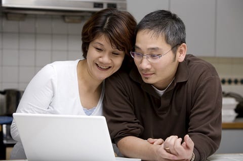 Couple looking at laptop.
