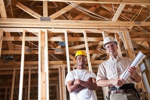 Multi-ethnic workers (20s and 30s) in house under construction.