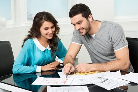 Couple reveiwing home design.