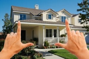 Hands framing a home.