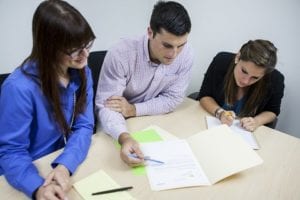 A couple reviewing paperwork with Realtor.