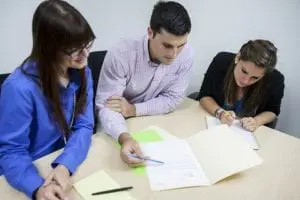 A couple reviewing paperwork with Realtor.