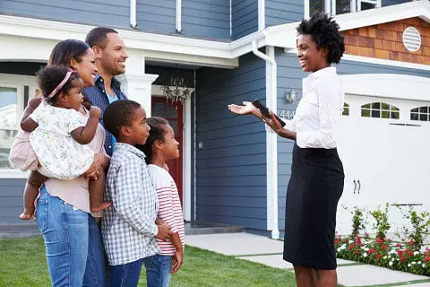 Realtor showing a home to a young family.