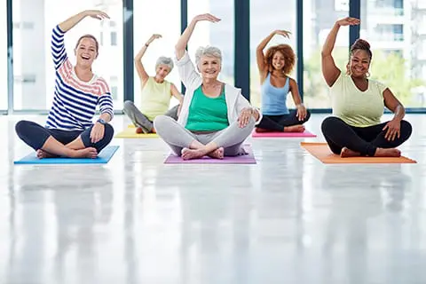 Shot of a group of women doing yoga indoors. 