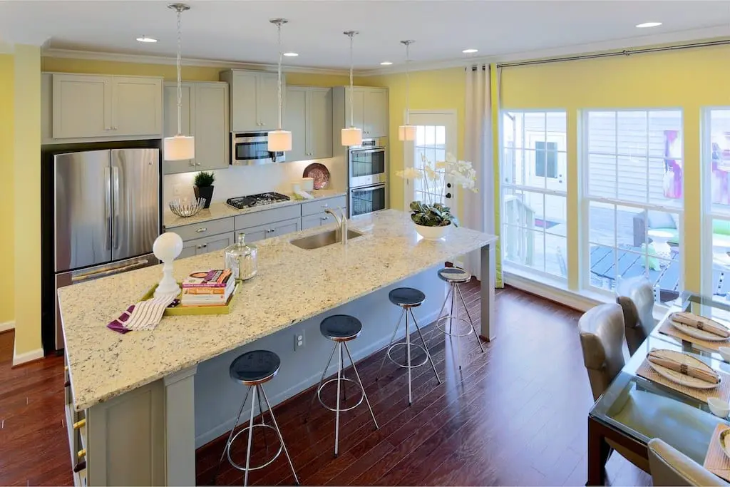 Kitchen with large island and yellow walls